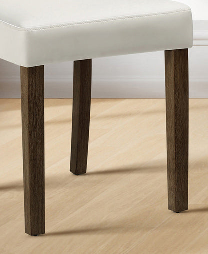 Chair with white cushioned seat and dark wooden legs on a wooden floor.