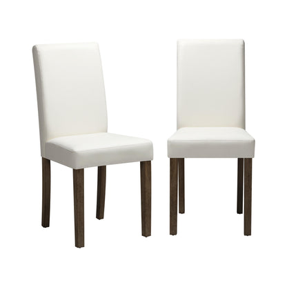 A pair of white upholstered dining chairs with brown wooden legs.
